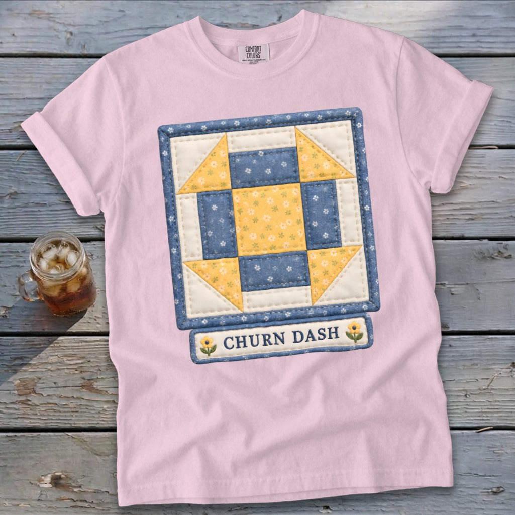 Pink t-shirt with a Churn Dash quilt block design and text.